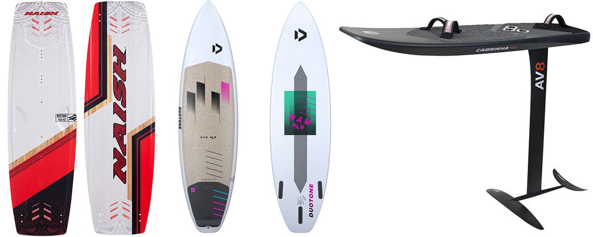 Different types of kitesurfing boards including twintip, surfboard, hydrofoil, and tiki board lined up on the beach.